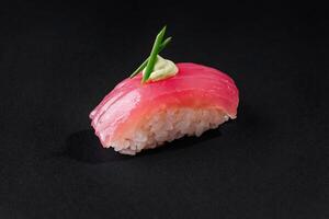 Gourmet tuna nigiri sushi with wasabi on black background photo