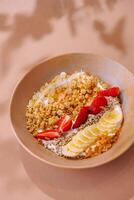 Healthy granola breakfast bowl with fruit toppings photo