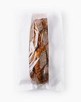 Fresh baguette in paper bag isolated on white photo