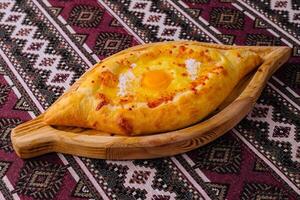 Traditional georgian khachapuri on wooden board photo