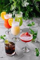 Variety of refreshing cocktails on rustic table photo