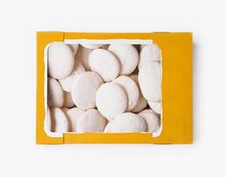 Box of white meringue cookies on white background photo