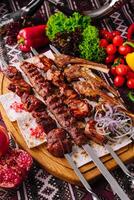 Traditional grilled shashlik skewers on wooden board photo