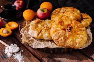 Homemade fruit galettes on rustic table photo