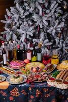 Festive holiday feast with decorated christmas tree photo