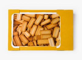 Box of salted breadsticks isolated on white photo