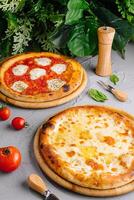 Gourmet margherita and cheese pizzas on rustic table photo