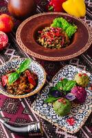 Traditional ethnic cuisine on ornate tablecloth photo