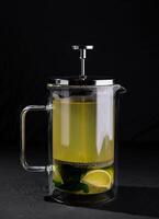 Fresh lime tea in glass french press photo