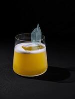 Elegant cocktail with a decorative leaf garnish photo