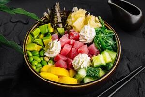 Fresh poke bowl with tuna and vegetables photo