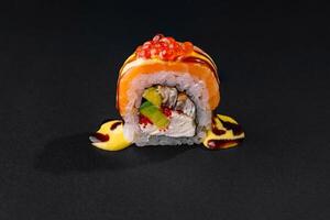 Exquisite sushi roll with salmon and caviar photo