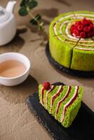 Green tea matcha cake with fresh raspberries photo