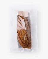 Artisan bread in paper bag isolated on white photo