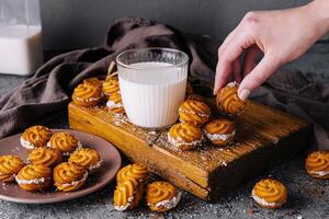 Fresco horneado galletas con Leche en de madera tablero foto