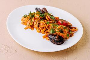 Delectable seafood pasta on white plate photo