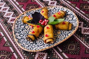 Traditional stuffed grape leaves on ornate plate photo