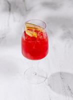 Elegant red cocktail on marble background photo