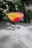 Elegant cocktail with colorful rim on gray background photo