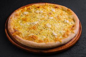 Fresh baked cheese pizza on wooden board photo