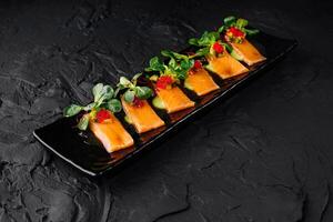 Gourmet smoked salmon appetizer on dark background photo