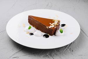 Gourmet chocolate tart on white plate photo