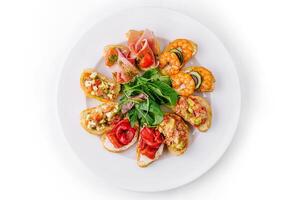 Gourmet bruschetta platter on white background photo