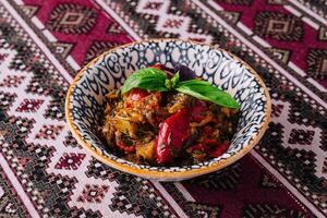 Authentic spicy aubergine stew in traditional bowl photo