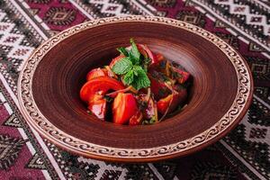 Traditional georgian salad on rustic tableware photo