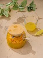 Refreshing citrus infused water in glass dispenser photo