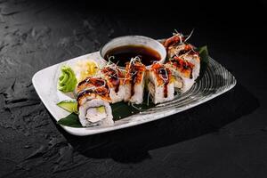 Delectable sushi roll platter with soy sauce photo