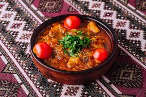 Traditional clay pot stew with fresh herbs photo