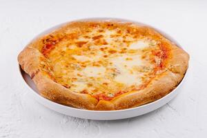 Fresh cheese pizza on white plate photo