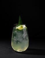 Refreshing lime cocktail on dark background photo