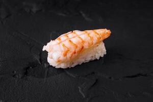 Fresh shrimp sushi on dark slate background photo