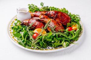 Gourmet roast quail on arugula salad photo