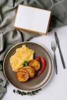 Plate with mashed potatoes and vegetable cutlets top view photo