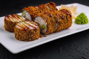 Crunchy spicy sushi roll on elegant plate photo