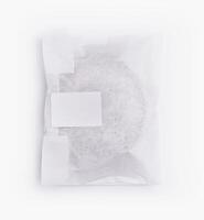 Sealed paper bag with blank label on white background photo