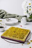 Pistachio cake on elegant table setting with coffee photo