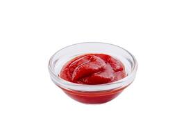 Bowl of fresh tomato ketchup isolated on white photo