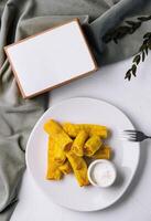 Spring rolls with dip and open blank menu book on a table photo