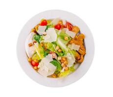 Fresh caesar salad on white plate photo