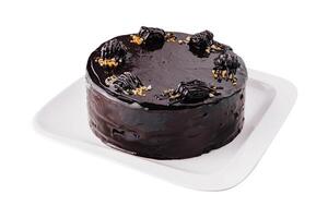 Decadent chocolate ganache cake on white plate photo