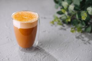 Refreshing spiced tea latte in glass cup photo