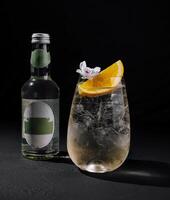 Elegant gin tonic cocktail with orange slice photo