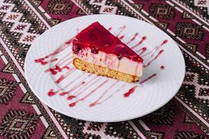 Delicious raspberry cheesecake slice on plate photo