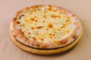 Fresh baked cheese pizza on wooden board photo