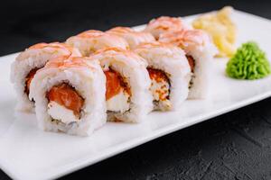 Delicious shrimp sushi roll on white plate photo