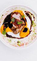 Gourmet pork tenderloin with colorful puree photo